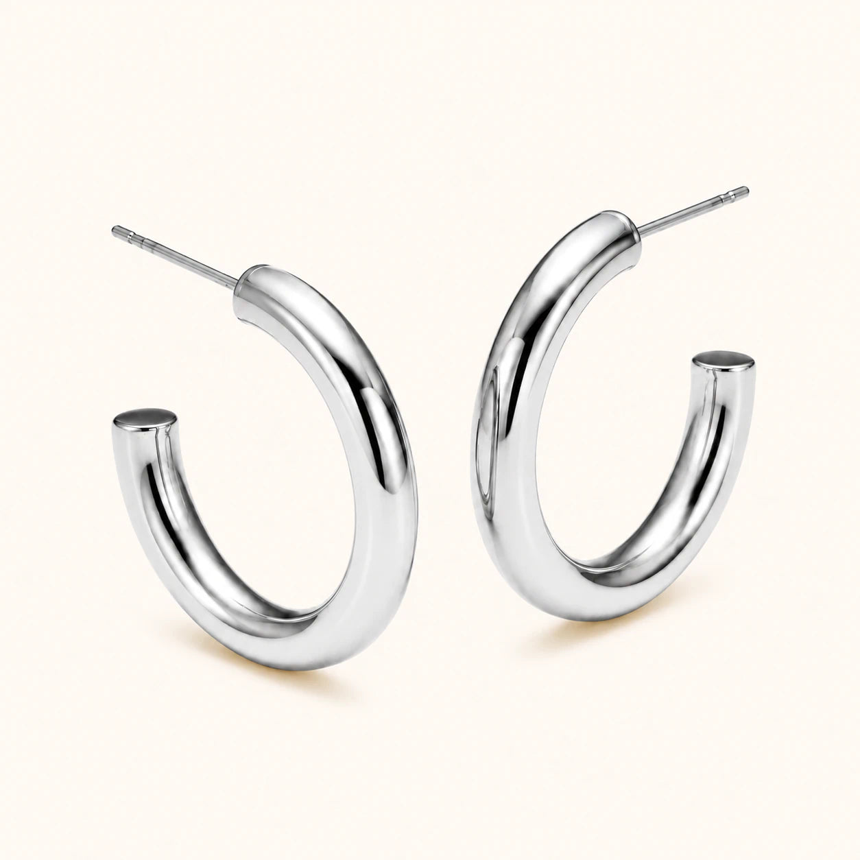 Pair of silver hoop earrings on a white background